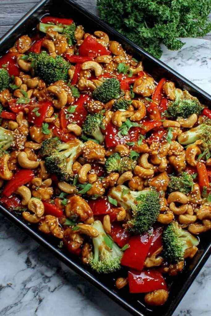 Sheet Pan Cashew Chicken: A High-Protein, One-Pan Wonder 6 Sheet pan cashew chicken with broccoli bell peppers and cashews on a baking sheet