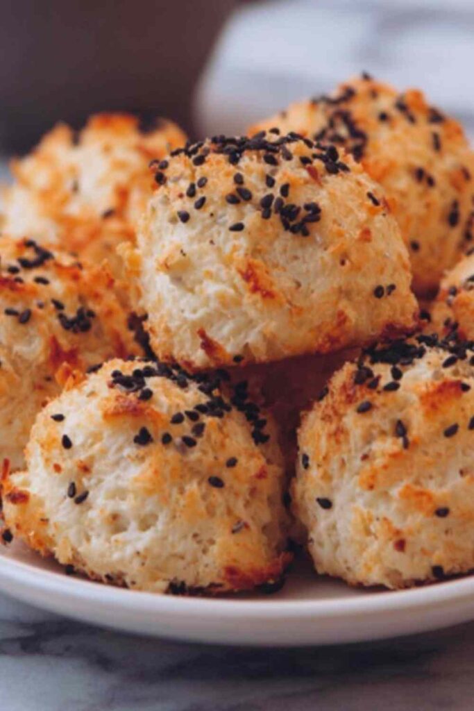 Everything bagel cottage cheese bites in white bowl topped with fresh chives and sesame seeds