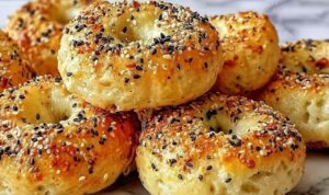 High protein bagel bites on baking sheet with everything bagel seasoning