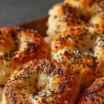 High protein bagel bites topped with everything seasoning on white plate