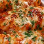 High protein creamy garlic cheesy chicken potatoes in skillet with melted cheese and fresh parsley