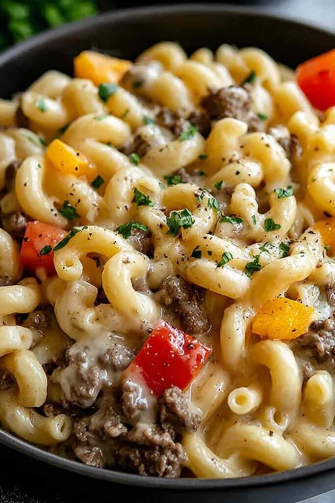 High Protein Philly Cheesesteak Mac and Cheese 6 High protein Philly cheesesteak mac and cheese in a skillet with melted provolone and fresh parsley