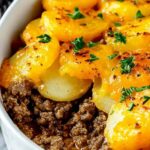 Hobo casserole with golden crispy tater tots and melted cheddar cheese in a 9x13 baking dish