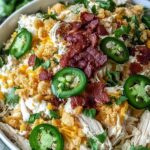 Jalapeno popper chicken salad in bowl with bacon and cheddar cheese