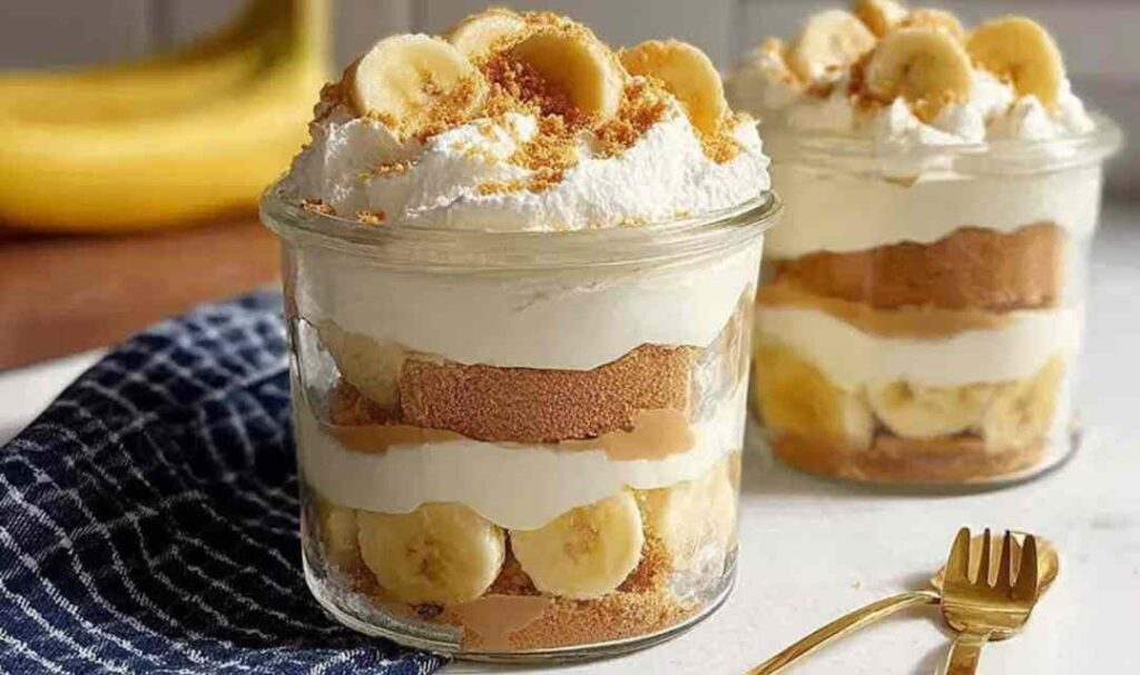 Protein banana pudding layered in clear glass with vanilla wafers and fresh banana slices