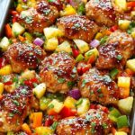 Sheet Pan Hawaiian Chicken with pineapple chunks and colorful bell peppers on baking sheet ready to serve