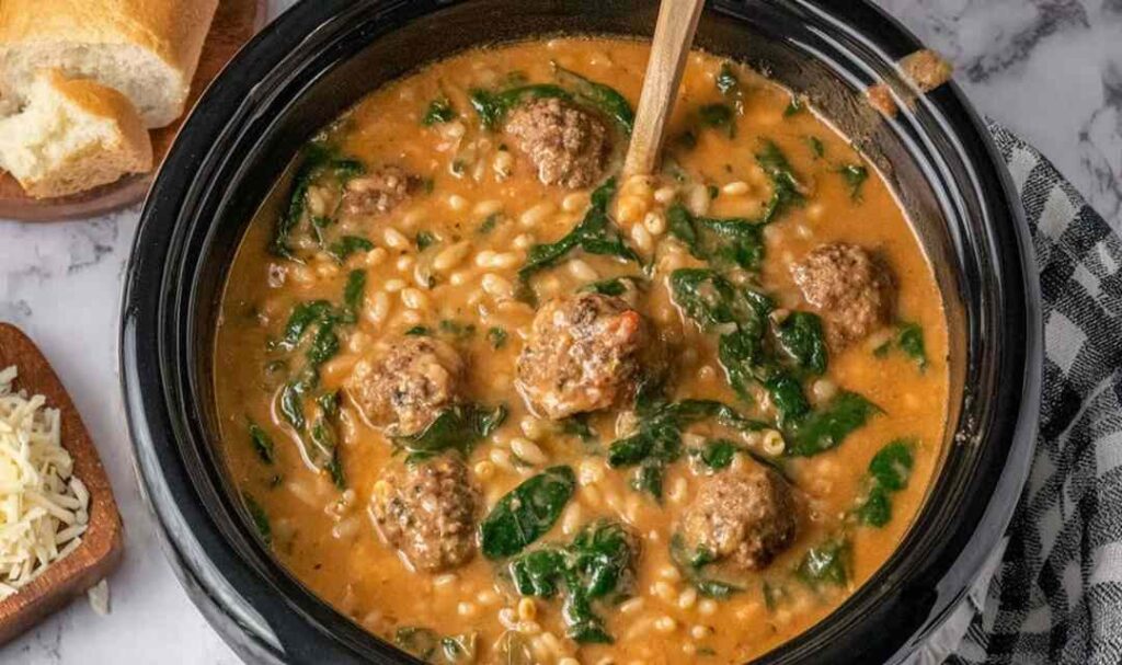 Slow Cooker Meatball Soup 5 Slow cooker meatball soup in a white bowl topped with fresh parsley and grated Parmesan cheese