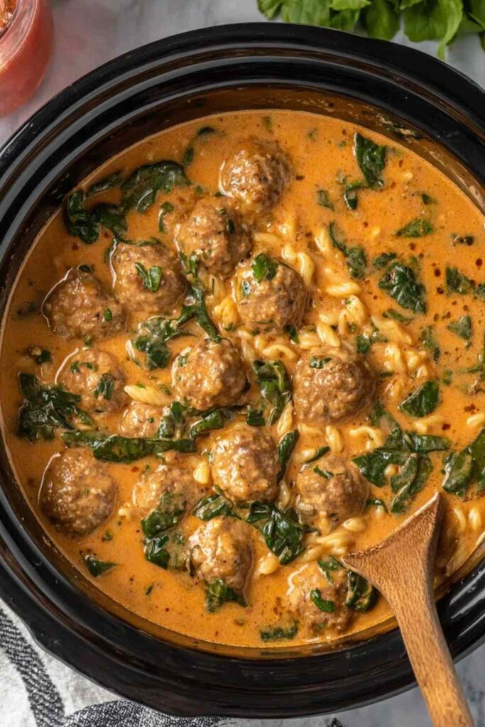 Slow Cooker Meatball Soup 6 Slow cooker meatball soup in a white bowl topped with fresh parsley and grated Parmesan cheese