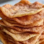 Sourdough discard cinnamon sugar crisps on white plate with coffee cup