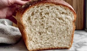 Easy Sourdough Discard Sandwich Bread Sliced easy sourdough discard sandwich bread on cutting board showing soft fluffy texture