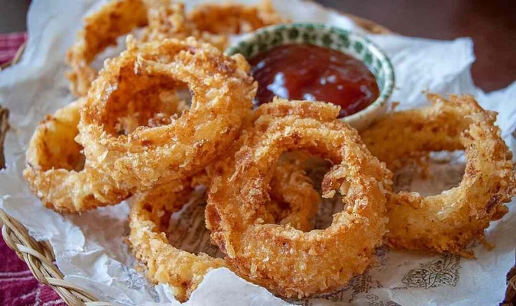 Sourdough Onion Rings 5 Golden crispy sourdough onion rings on white plate with dipping sauce