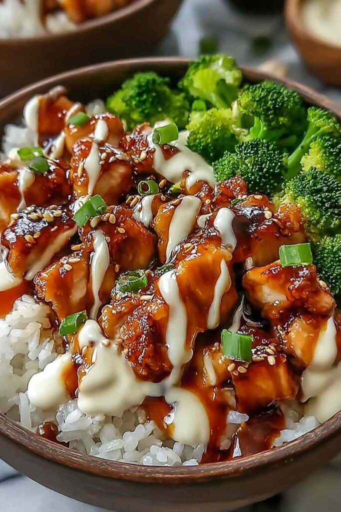 Sticky Chicken Rice Bowls - An Incredible Ultimate Recipe for Every Occasion 6 Sticky chicken rice bowls with glazed chicken thighs, jasmine rice, broccoli, carrots, and sesame seeds in a white bowl
