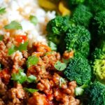 Sweet and spicy ground turkey and broccoli bowls served over brown rice with sesame seeds and green onions