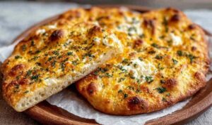 Cottage cheese flatbread on a baking sheet with golden brown edges and everything bagel seasoning on top