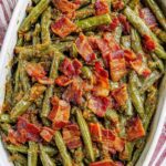 5-ingredient crack green beans glazed in sweet soy sauce in a white ceramic baking dish