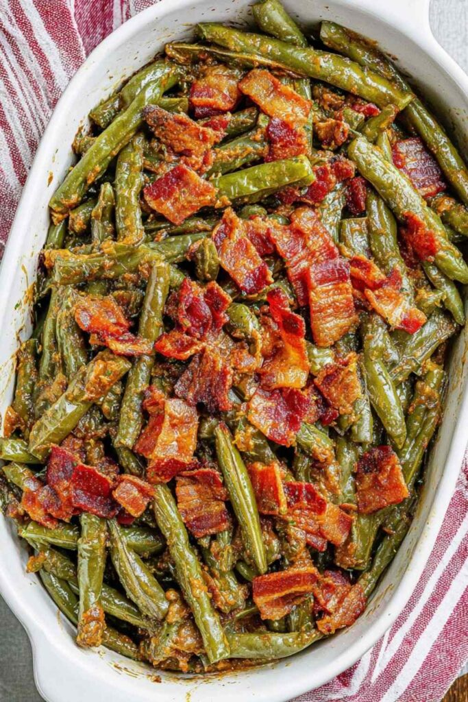 5-ingredient crack green beans glazed in sweet soy sauce in a white ceramic baking dish