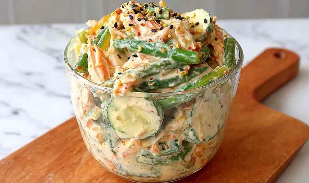 Creamy Asian cucumber salad bowl with sesame-ginger dressing, edamame, and sesame seeds