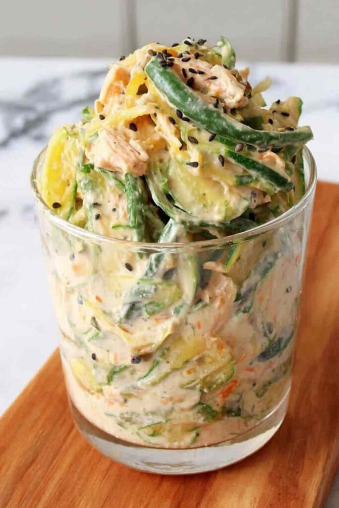 Creamy Asian cucumber salad bowl with sesame-ginger dressing, edamame, and sesame seeds