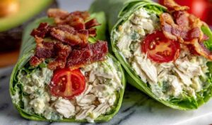 California Club Wraps sliced in half showing layers of turkey, bacon, avocado, and fresh vegetables
