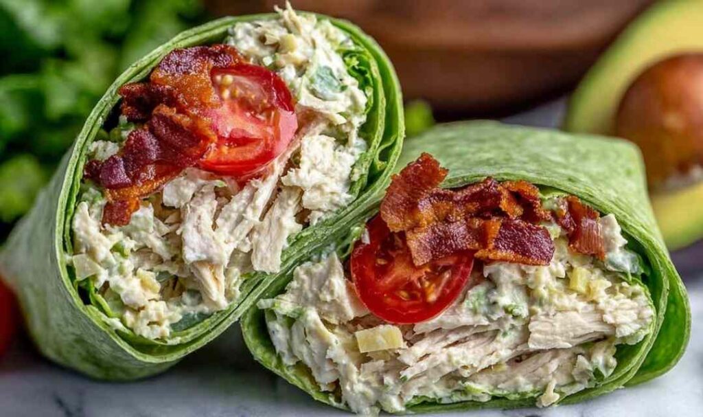 California Club Wraps sliced in half showing layers of turkey, bacon, avocado, and fresh vegetables