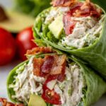 California Club Wraps sliced in half showing layers of turkey, bacon, avocado, and fresh vegetables