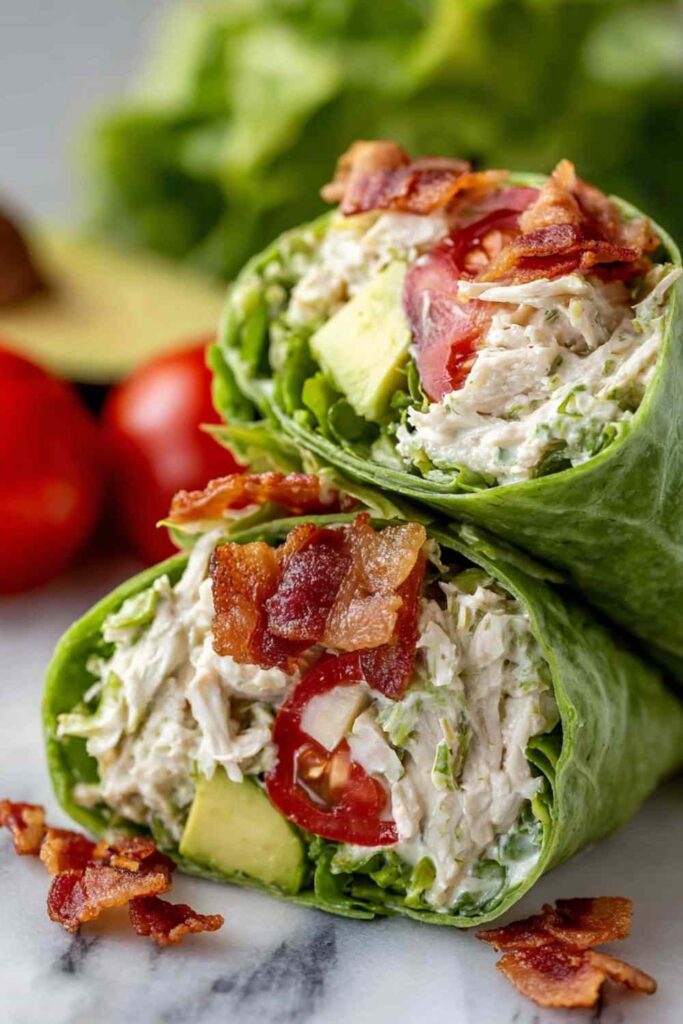 California Club Wraps sliced in half showing layers of turkey, bacon, avocado, and fresh vegetables