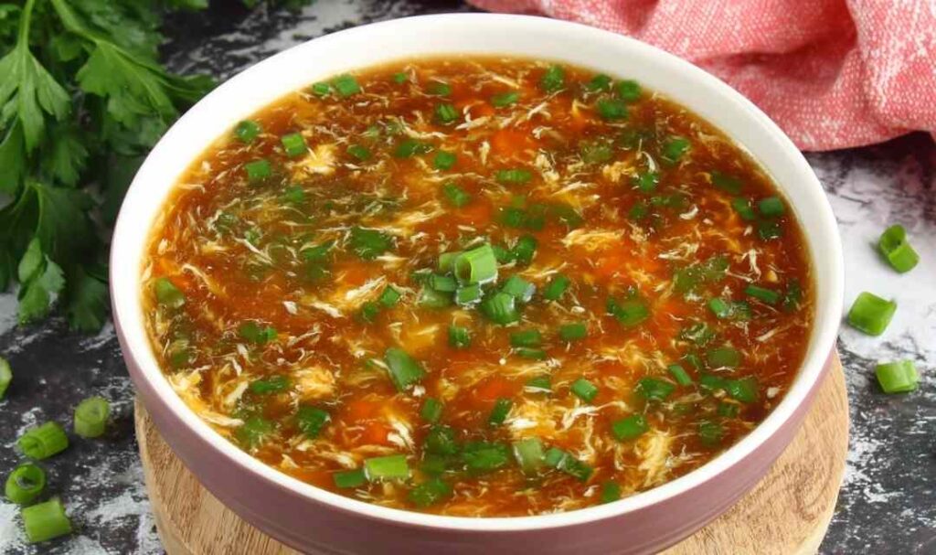 Bowl of authentic Chinese hot and sour soup with egg ribbons, tofu, and mushrooms