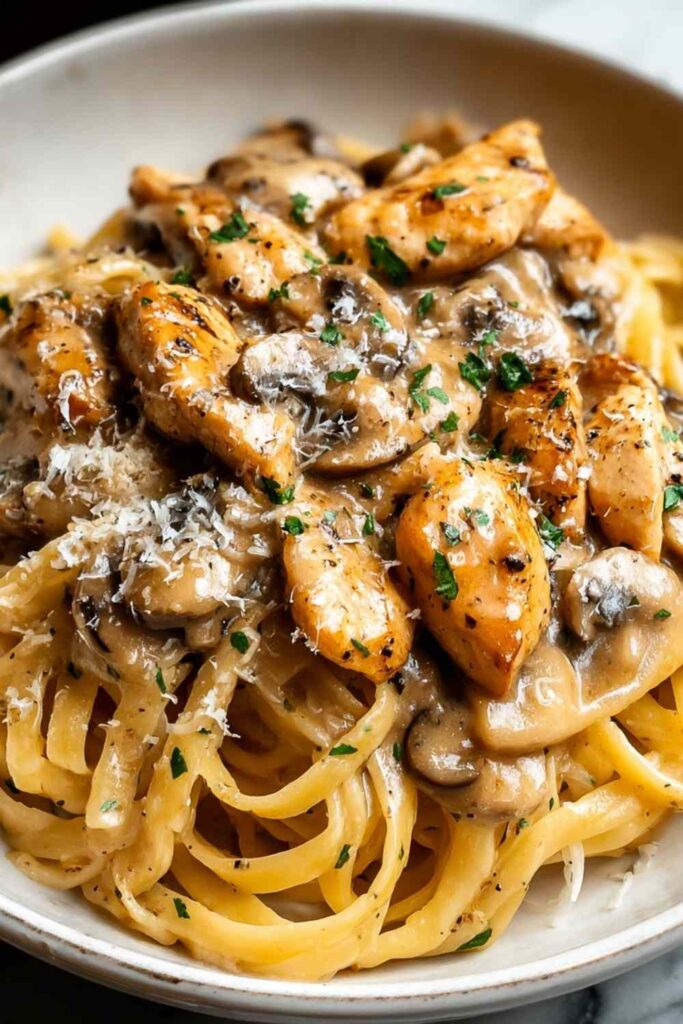 Chicken Marsala Pasta 6 Creamy Chicken Marsala Pasta with mushrooms and Parmesan in a large skillet