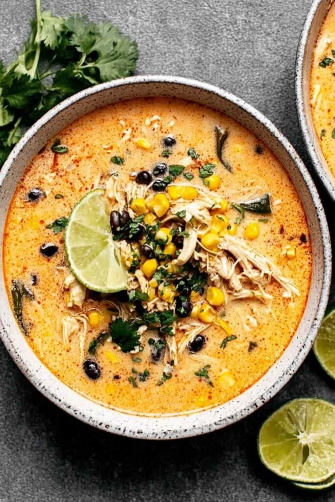 Chicken Poblano Soup 6 Creamy chicken poblano soup in a bowl garnished with fresh cilantro and lime wedges