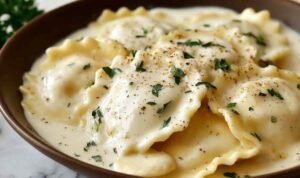 Creamy lemon garlic sauce for ravioli in a pan with Parmesan and fresh parsley