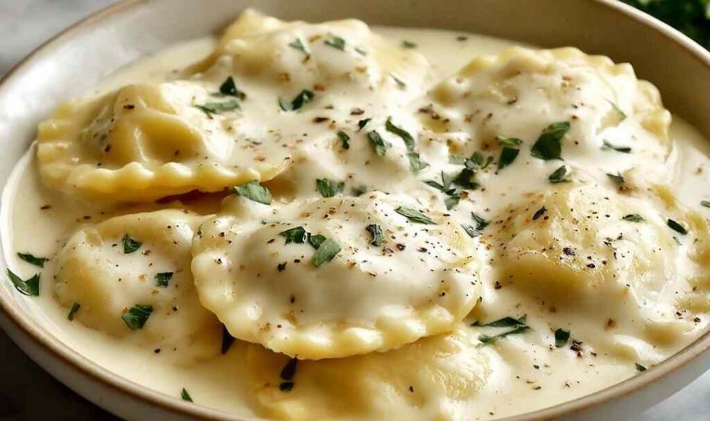 Creamy lemon garlic sauce for ravioli in a pan with Parmesan and fresh parsley