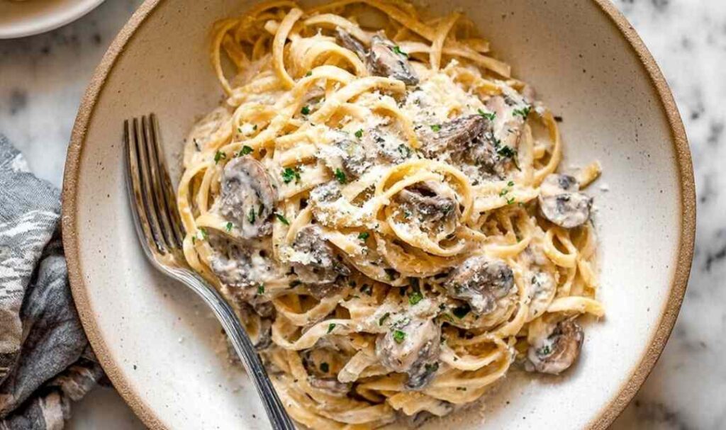 Creamy Mushroom Pasta Sauce 5 Creamy garlic butter chicken bowtie pasta in a skillet topped with fresh parsley and Parmesan cheese