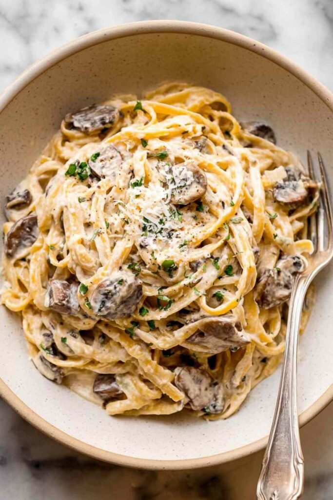 Creamy Mushroom Pasta Sauce 6 Creamy garlic butter chicken bowtie pasta in a skillet topped with fresh parsley and Parmesan cheese