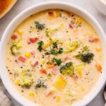 Bowl of creamy vegetable soup garnished with fresh parsley