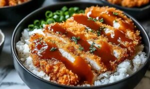 Japanese Katsu Bowls with tonkatsu sauce drizzled over crispy panko beef cutlets and short-grain rice