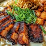 Fiery chicken ramen in a white bowl topped with a soft-boiled egg, green onions, and sesame seeds over creamy garlic broth