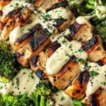Grilled chicken broccoli bowls with creamy garlic sauce served over white rice with fresh parsley garnish