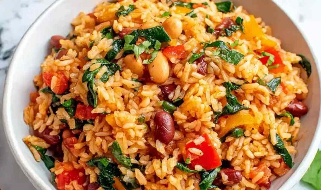 Mediterranean rice and beans in a skillet with fresh parsley, dill, and lemon