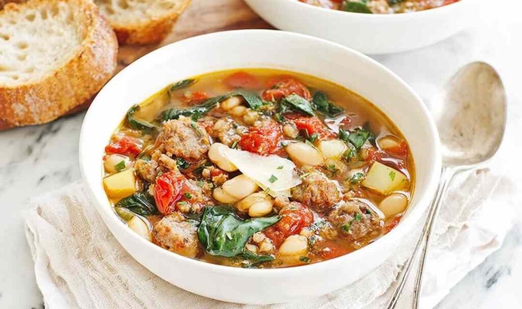 Italian Vegetable Soup 5 Bowl of Italian vegetable soup with cannellini beans, ditalini pasta, fresh spinach, and grated Parmesan cheese