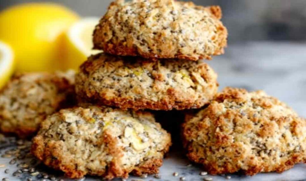 Lemon Chia Breakfast Cookies 5 Lemon chia breakfast cookies stacked on a white plate with fresh lemon slices and zest