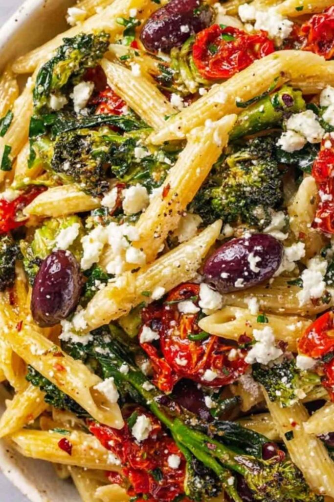 Mediterranean Pasta 6 Bowl of Mediterranean pasta with sun-dried tomatoes, olives, artichokes, spinach, and crumbled feta cheese