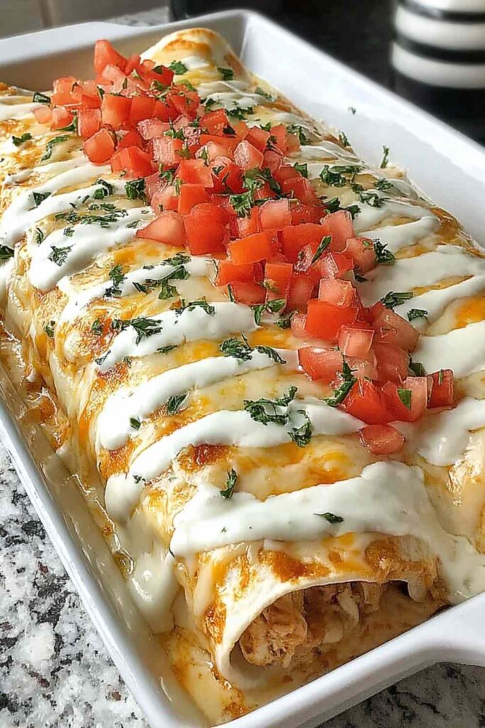 Queso chicken enchiladas baked in a dish with creamy homemade queso sauce and melted cheese