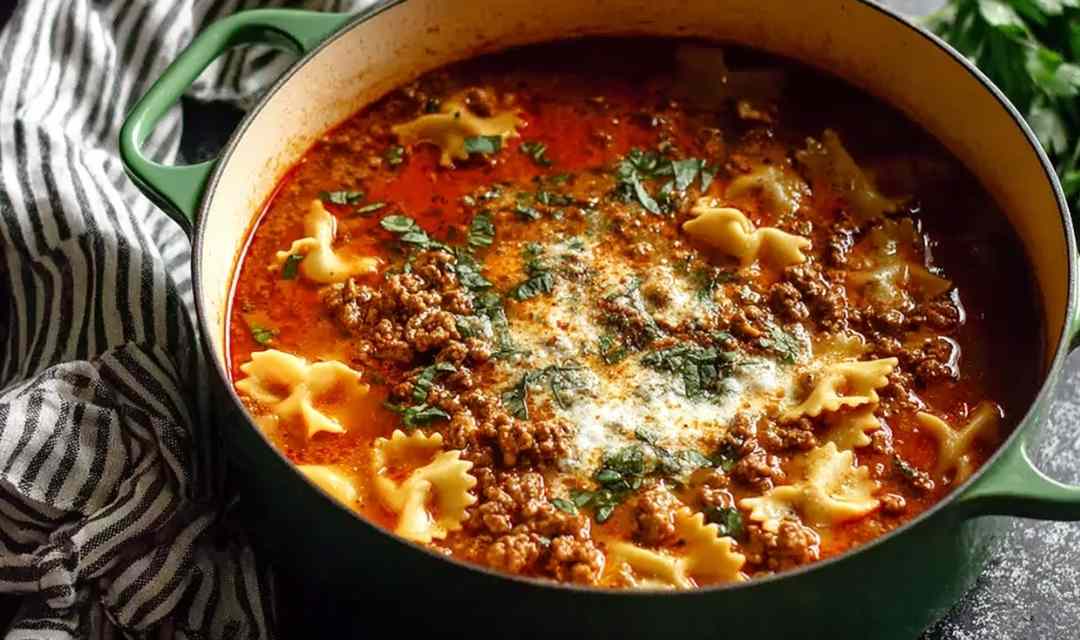 Simple lasagna soup with Italian sausage and ricotta topping in a white bowl