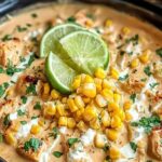 Slow cooker street corn chicken served in a bowl topped with cotija cheese, cilantro, and chili powder