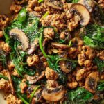Turkey Spinach Mushroom Skillet with browned ground turkey, cremini mushrooms, and wilted spinach in a garlic herb sauce served in a large skillet