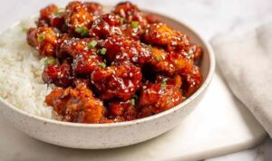 Crispy air fryer General Tso's chicken tossed in homemade sweet and spicy sauce served over steamed white rice