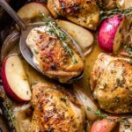 Apple chicken sheet pan dinner with caramelized brown sugar apples and onions on a rimmed baking sheet