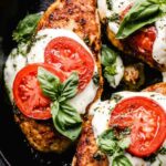 Chicken Margherita with melted fresh mozzarella and balsamic glaze in a cast iron skillet