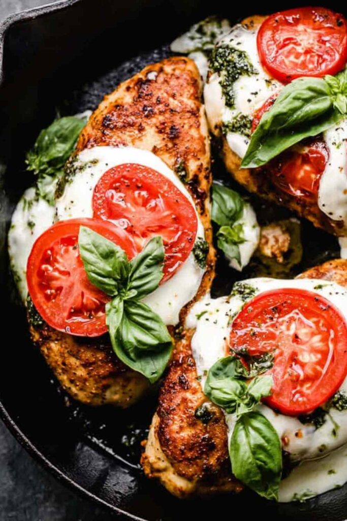 Chicken Margherita with melted fresh mozzarella and balsamic glaze in a cast iron skillet