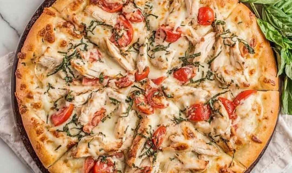 Chicken margherita pizza with grilled chicken slices, fresh basil, and melted mozzarella on a crispy golden crust